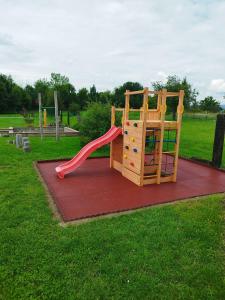 a playground with a slide in a park at Resort Radslavice in Přerov