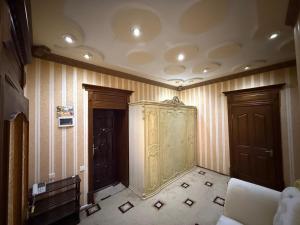 a room with two doors and a couch in it at The Skyline Apartments in Samarkand