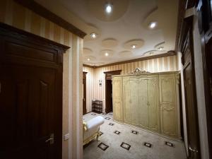 a room with a large green cabinet in a room at The Skyline Apartments in Samarkand