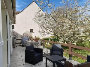 a patio with chairs and a table and a fence at Chambre Cosy Eaubonne in Eaubonne