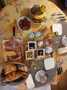 a table with a table cloth with food on it at Chambre Cosy Eaubonne in Eaubonne