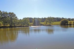 a large lake with a fountain in the middle of it at De pelage in Saint-Just-le-Martel