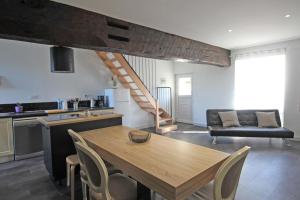 a kitchen and dining room with a wooden table and chairs at De pelage in Saint-Just-le-Martel