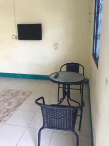 a table and chair in a room with a television at Yada House in Nong Ki