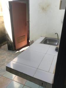 a bathroom with a sink next to a door at Yada House in Nong Ki
