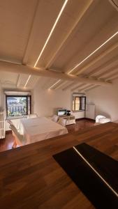 a large bedroom with a large bed and a window at Casa MiA in Salò