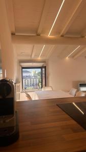 a large room with a bed and a window at Casa MiA in Salò