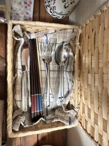 a basket with utensils sitting on a wall at Mori de house in kobe 2 in Kobe