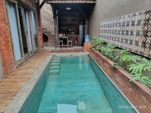 a small swimming pool in the middle of a house at Jagad Villa with 3 Bedroom in Ungasan