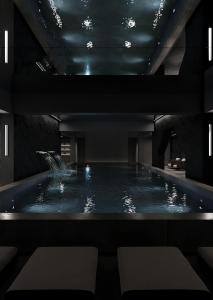 a swimming pool with a fountain in a building at Mildom Residence in Almaty