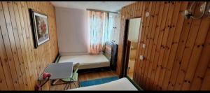 a small bedroom with a bed and a window at Apartma NADIŽA in Borjana