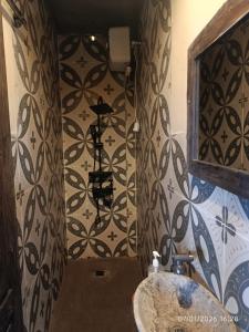 a bathroom with a sink and a wall at Jagad Villa with 3 Bedroom in Ungasan +22 photos