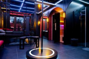 a room with a table and two stools in it at Love Apartament z sauną i jacuzzi in Katowice +3 photos