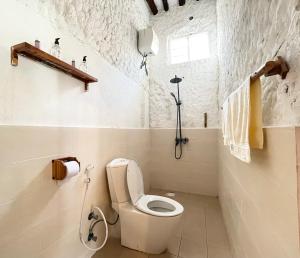 a white bathroom with a toilet and a shower at HA Beach Breeze in Jambiani +42 photos