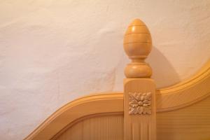 a wooden pillar with a flower carved into it at Hotel Tolderhof in San Candido +39 photos