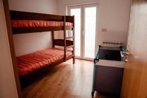 a room with two bunk beds and a window at Casa da avo Rita in Pêro Viseu +19 photos
