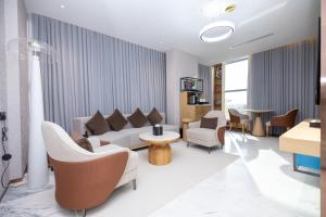 a living room with a couch and chairs and a table at 7Crown Tahliah Hotel in Riyadh