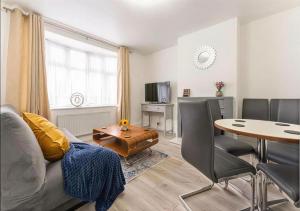 a living room with a couch and a table at Walsgrave Road 3BR Multi-Floor Apartment Unit - Free Parking & WiFi in Wyken