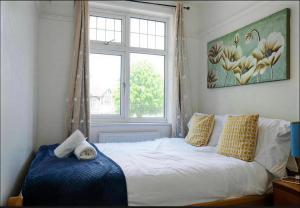 a bed in a bedroom with a large window at Walsgrave Road 3BR Multi-Floor Apartment Unit - Free Parking & WiFi in Wyken