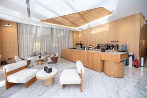 a lobby with a counter and aasteryasteryasteryasteryasteryasteryasteryasteryastery at 7Crown Tahliah Hotel in Riyadh