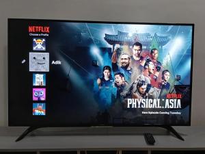 a flat screen tv with a movie on it at Homestay Makyu Kuala Kangsar in Kuala Kangsar