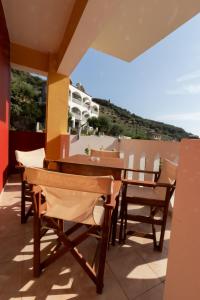 a table and chairs on a balcony with a view at Casa di Dandolo in Parga
