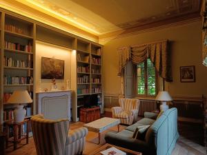a living room with a couch and chairs and a fireplace at Palazzo Guicciardi in San Bernardo