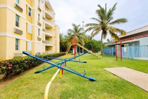 a playground in a yard next to a building at Beach condo with 3 bedrooms and ocean views in Rio Grande