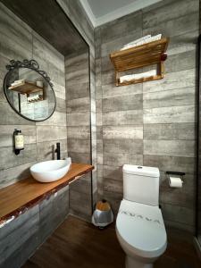a bathroom with a white toilet and a sink at Casa Do Campo in Peniche +92 photos
