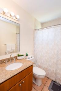 a bathroom with a sink and a toilet and a mirror at Beach condo with 3 bedrooms and ocean views in Rio Grande +16 photos