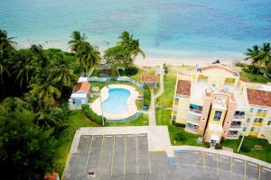 an aerial view of a resort with a swimming pool and the ocean at Beach condo with 3 bedrooms and ocean views in Rio Grande