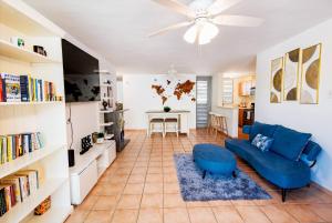 a living room with a blue couch and a table at Beach condo with 3 bedrooms and ocean views in Rio Grande