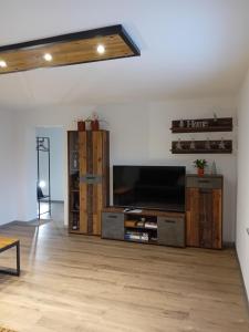 a living room with a flat screen tv at Apartma - Hiša Zofija in Slovenske Konjice