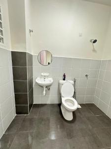 a bathroom with a toilet and a sink at Voila PD Homestay in Lukut +35 photos