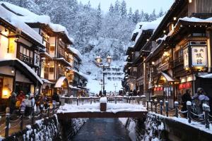 a street in a town covered in snow at Zaō Hütte 一棟貸し in Zao