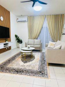a living room with a couch and a table at Voila PD Homestay in Lukut