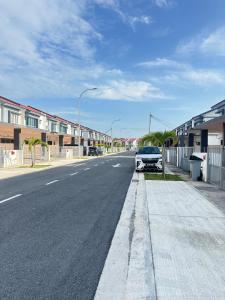 a street with a car parked on the side of the road at Voila PD Homestay in Lukut