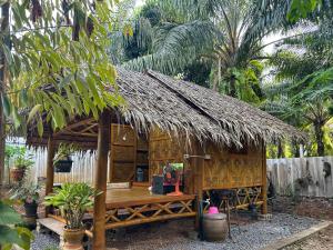 a small hut with a person sitting in it at Baan Panmala Homestay - Ao Luek, Krabi in Krabi
