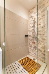 a shower in a bathroom with a glass shower stall at Ydor apartment in Hydra +4 photos