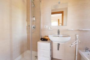 a white bathroom with a sink and a shower at Agriturismo Azzarone in Vieste +39 photos
