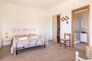 a bedroom with a bed and a chair in it at Agriturismo Azzarone in Vieste