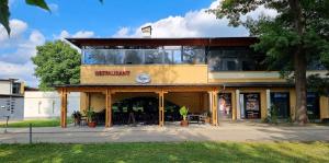 a store front with a building with glass at Deluxe Thermal Resort in Pápa