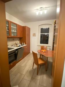 a kitchen with a wooden table and a table and a dining room at Stadtgarten in Meißen +4 photos