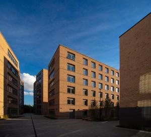 a brown brick building with two tall buildings at Stay at St Marks in Lincoln