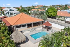 an aerial view of a house with a swimming pool at Villa CuraSea in Jan Thiel