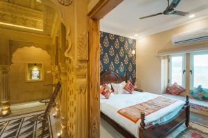 a bedroom with a bed and a window at The Rising Haveli in Jaisalmer