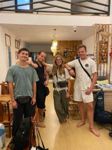 a group of people standing in a room at Dream station hostel in Pakse