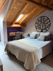 a bedroom with a large bed and a table at Casa Do Campo in Peniche