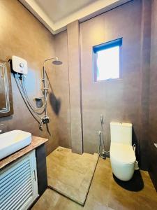 a bathroom with a toilet and a shower at Krishan Villa in Negombo +157 photos