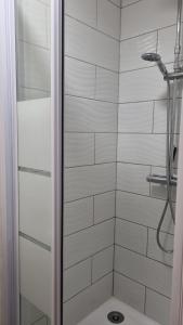 a bathroom with a shower with a glass door at accommodation à la ferme in Lubersac +18 photos